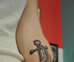 Anchor and feather tattoo