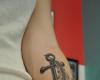 Anchor and feather tattoo