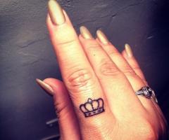 Crown finger tattoo