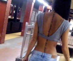 Arabic lettering spine tattoo