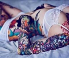 Girl tattoos on arm and ribs