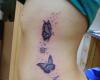 Tatuajes femeninos con mariposas e iniciales