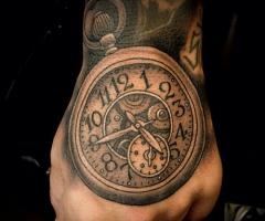 Realistic clock tattoo on hand