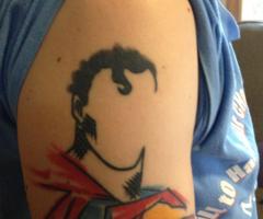 Superman tattoo on upper right arm