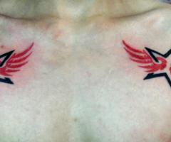 Star wing tattoo on chest