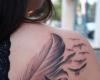 Feather with birds tattoo