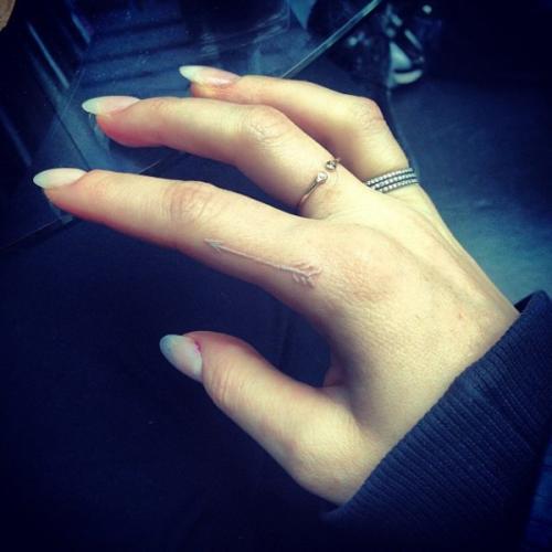 Ellie Goulding arrow white ink tattoo