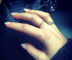 Ellie Goulding arrow white ink tattoo