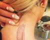 Rita Ora bird tattoo on neck
