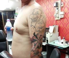 Clown skull and cross tattoo