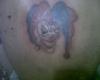 Tatuaje de payaso en la espalda