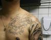 Dragon tattoo by libertad tattoo