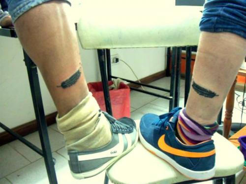 Friend feather tattoo on leg