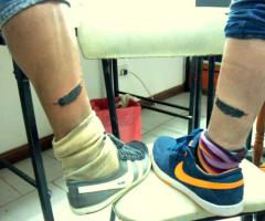 Friend feather tattoo on leg