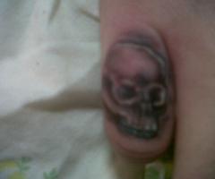 skull finger tattoo