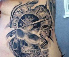 Skull and watch tattoo