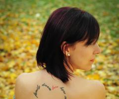 Heart quote tattoo on back