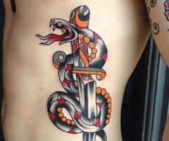Traditional snake and dagger tattoo