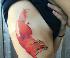 Fox tattoo on rib for women