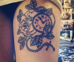 Clock tattoo on sexy leg