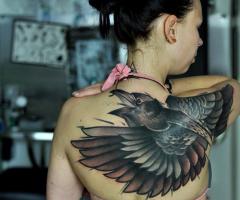 Bird on back tattoo