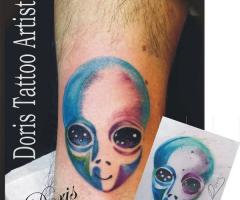 An alien color arm tattoo 